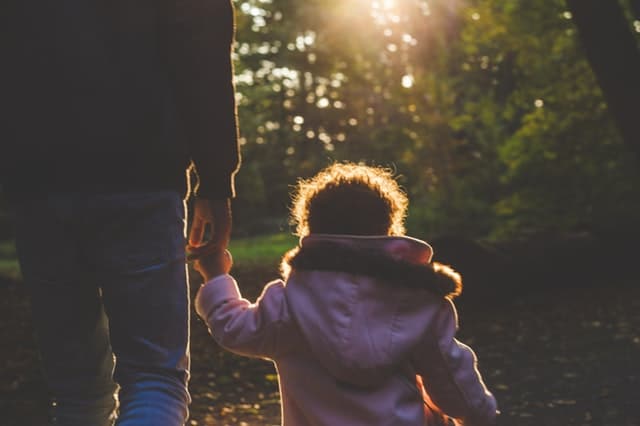 parent taking a walk with child