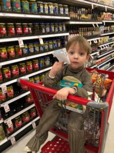 child in trolley while shopping